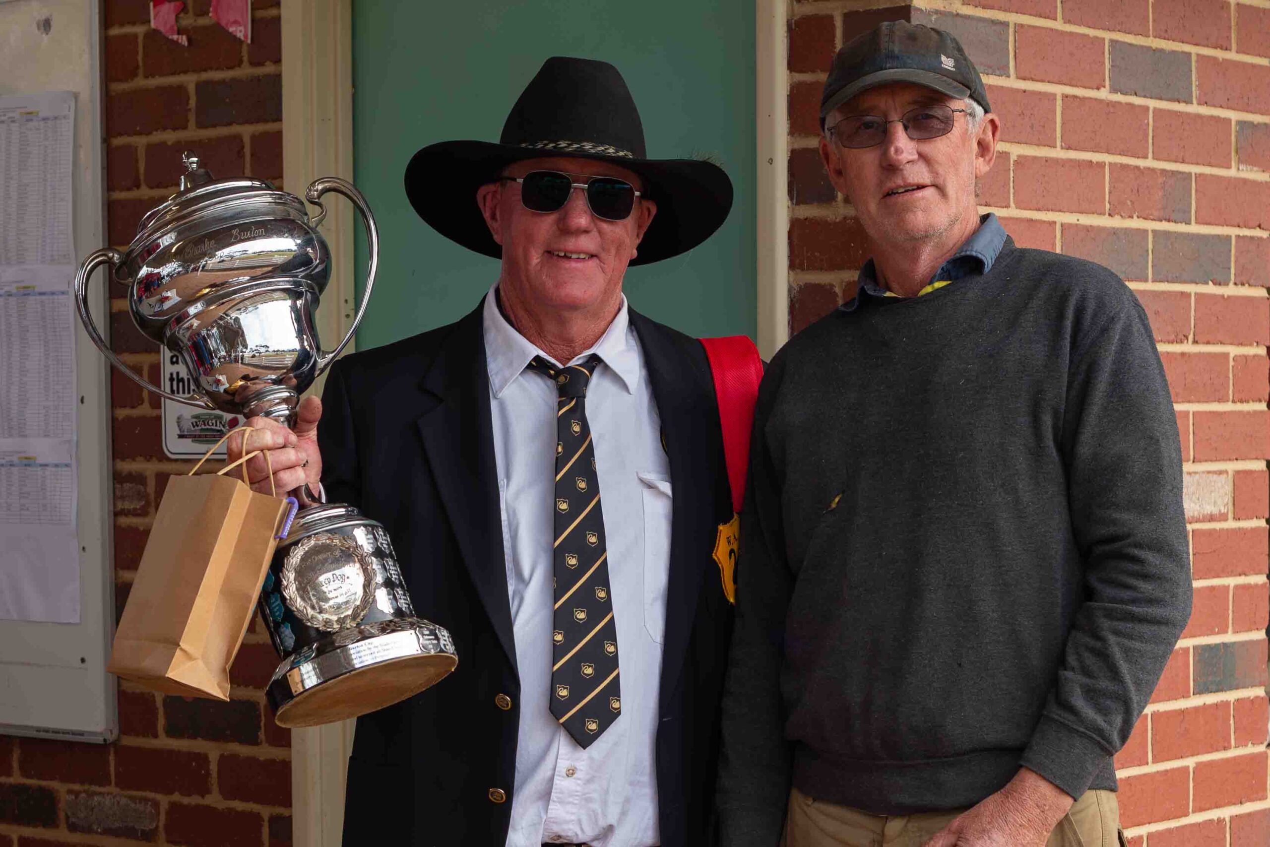 The new WA Open Champion, Neil Kristiansen with Badgingarra Oscar, is presented the Champions Trophy by Wagin Shire President Phillip Blight.